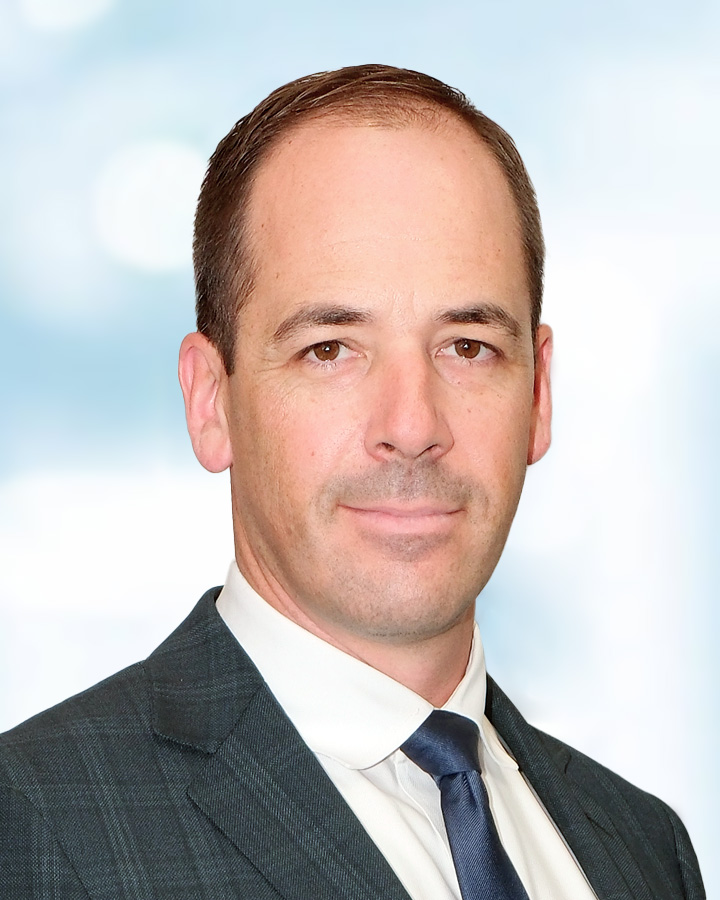 Portrait of Joel Couture on a light blue background